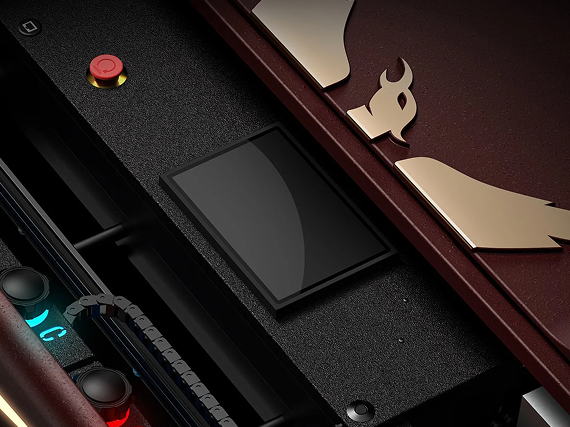 Close-up of the Kegel Atlas lane machine control panel with an integrated touchscreen display, red button, and gold phoenix emblem on the maroon lid